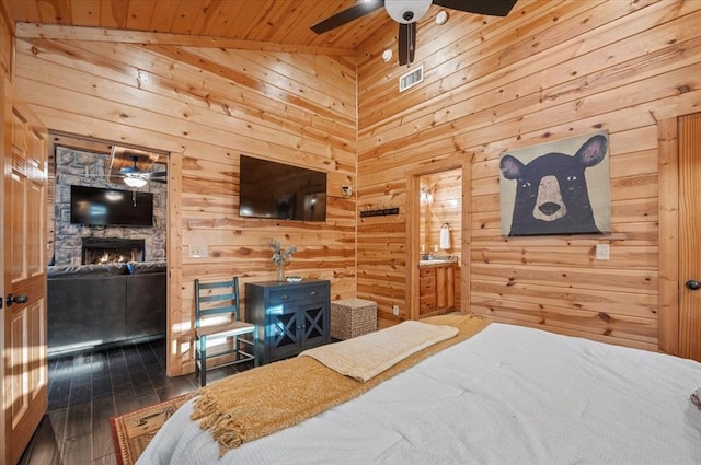 bedroom with dark wood-type flooring, wooden ceiling, and wood walls