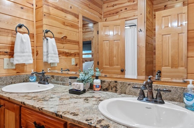 bathroom with vanity and wooden walls