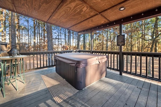 wooden deck with a hot tub