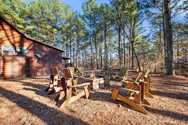 view of yard with a fire pit