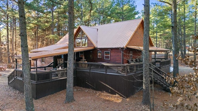 rear view of property featuring a deck