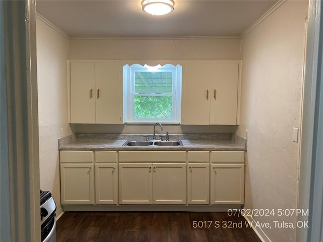 kitchen with sink, dark hardwood / wood-style flooring, stainless steel electric range, white cabinets, and ornamental molding