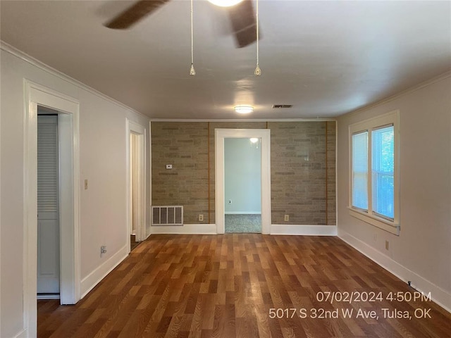 unfurnished room featuring ceiling fan, dark hardwood / wood-style flooring, and ornamental molding