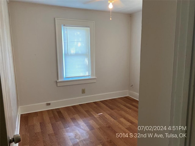 empty room featuring ceiling fan, hardwood / wood-style floors, and ornamental molding