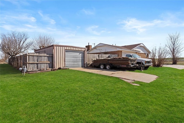 view of yard featuring an outbuilding and a garage