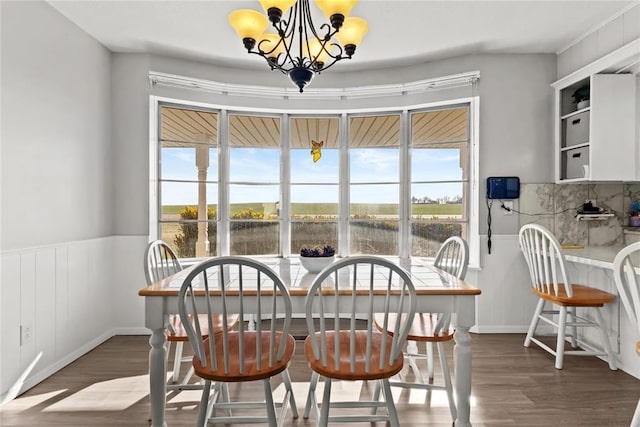 dining space featuring a notable chandelier and dark hardwood / wood-style flooring