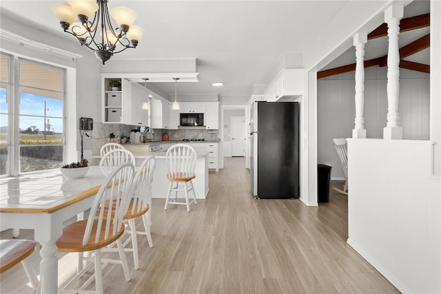 dining area with a chandelier and light wood-type flooring