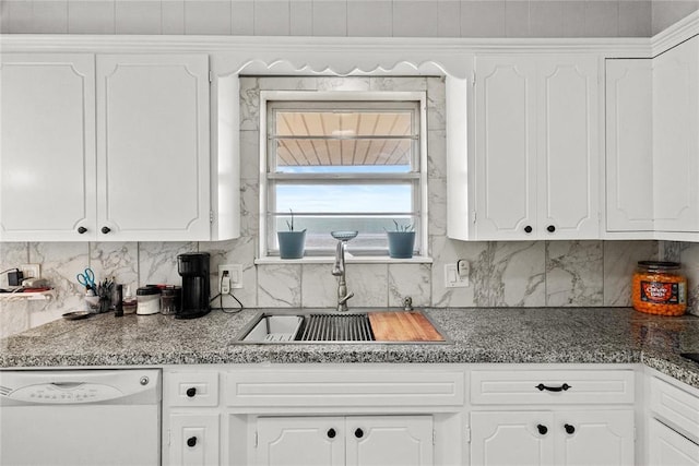 kitchen with white cabinets, white dishwasher, tasteful backsplash, and sink