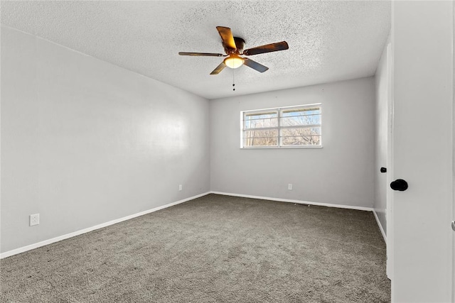 spare room with carpet, ceiling fan, and a textured ceiling