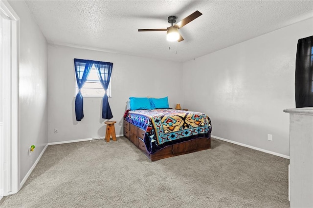 carpeted bedroom with a textured ceiling and ceiling fan