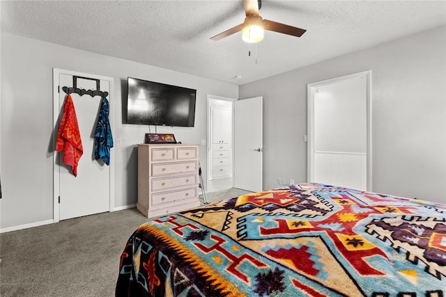 bedroom featuring ceiling fan, carpet floors, and a textured ceiling