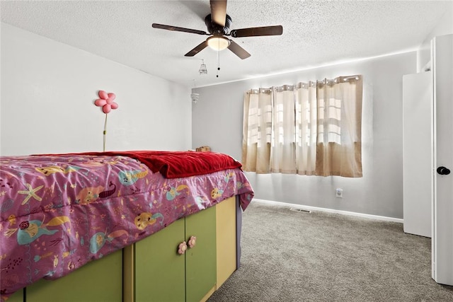 carpeted bedroom with a textured ceiling and ceiling fan