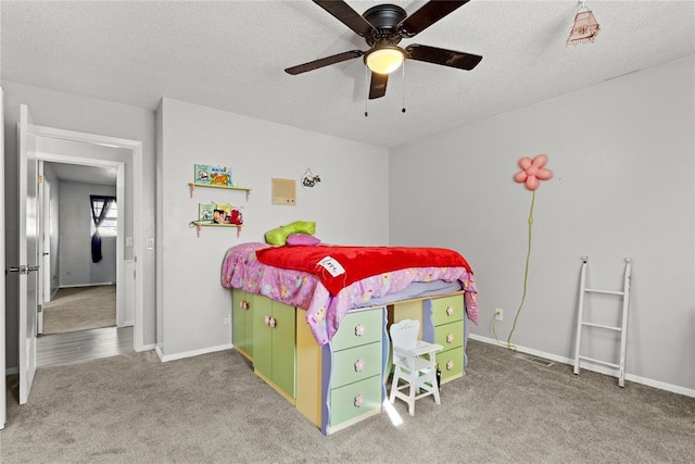 bedroom featuring carpet, ceiling fan, and a textured ceiling