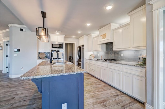 kitchen with tasteful backsplash, sink, decorative light fixtures, and appliances with stainless steel finishes