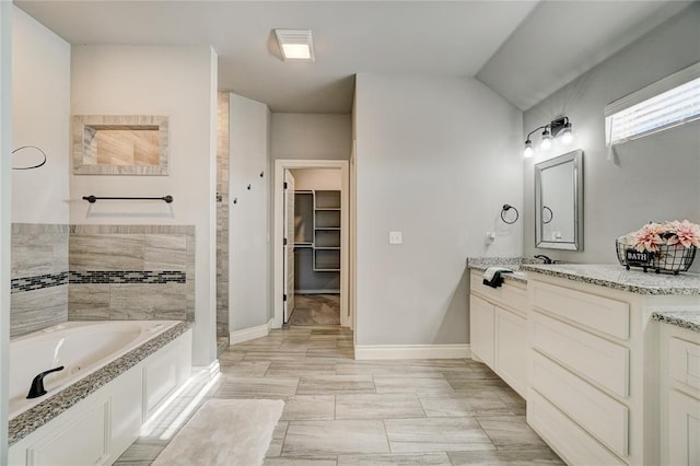 bathroom with vanity and a bathtub