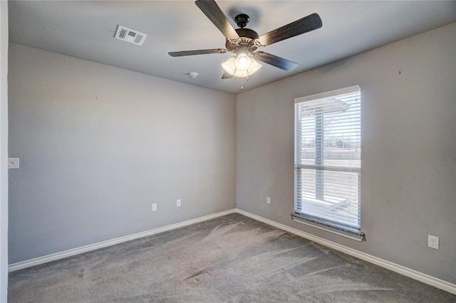 carpeted spare room with ceiling fan