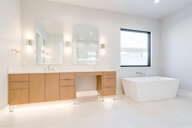 bathroom with tile patterned floors, vanity, and shower with separate bathtub