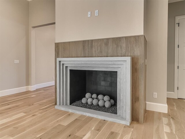 details featuring a fireplace and hardwood / wood-style flooring