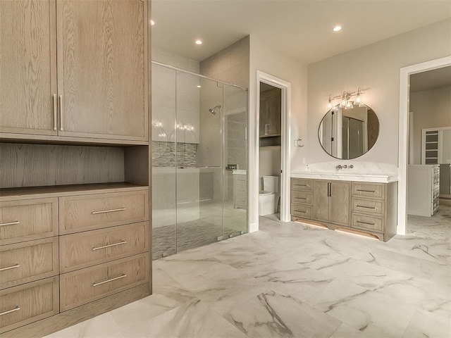 bathroom with an enclosed shower, vanity, and toilet