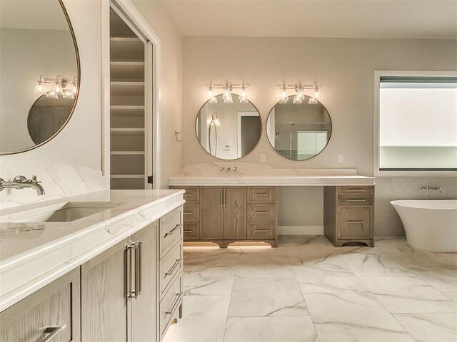 bathroom featuring vanity and a bath