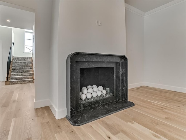 interior details featuring crown molding and hardwood / wood-style floors