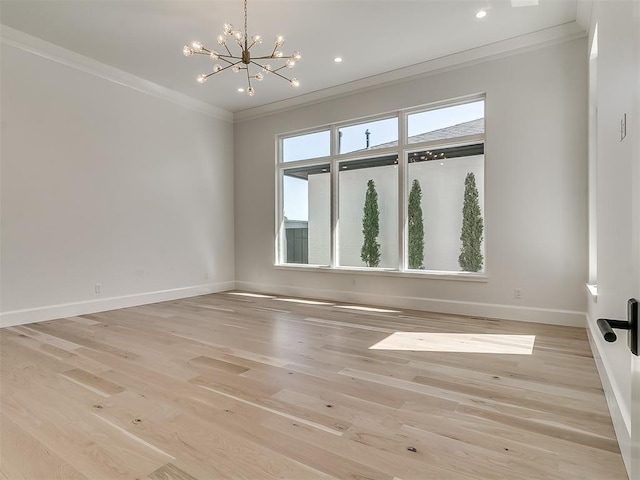 empty room with ornamental molding, light hardwood / wood-style flooring, and an inviting chandelier