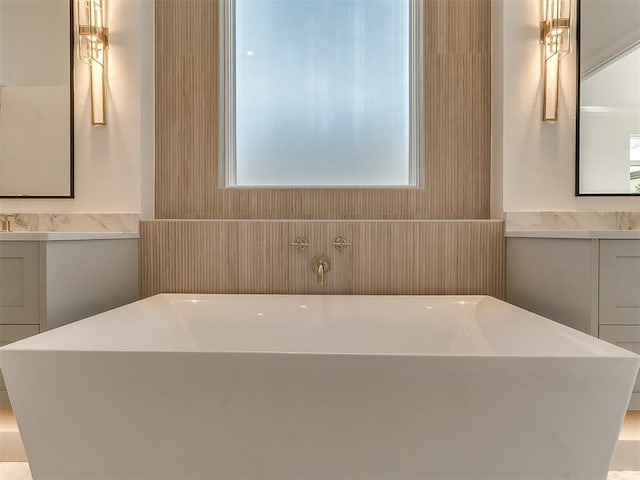 bathroom featuring vanity and a tub to relax in