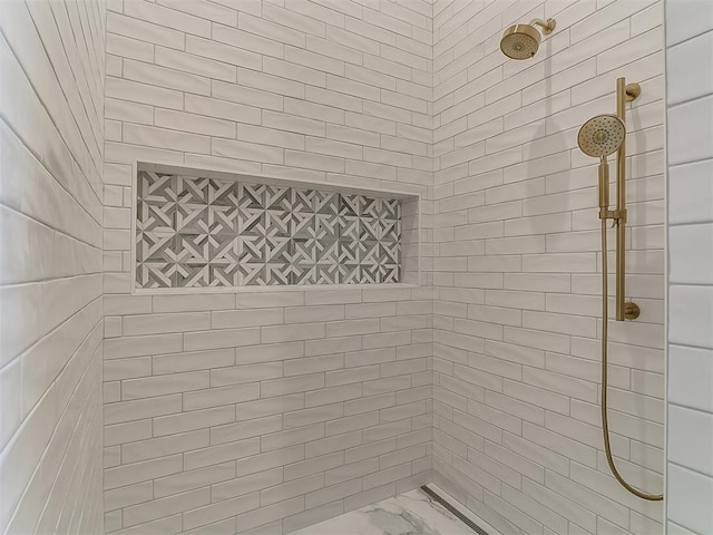 bathroom with a tile shower