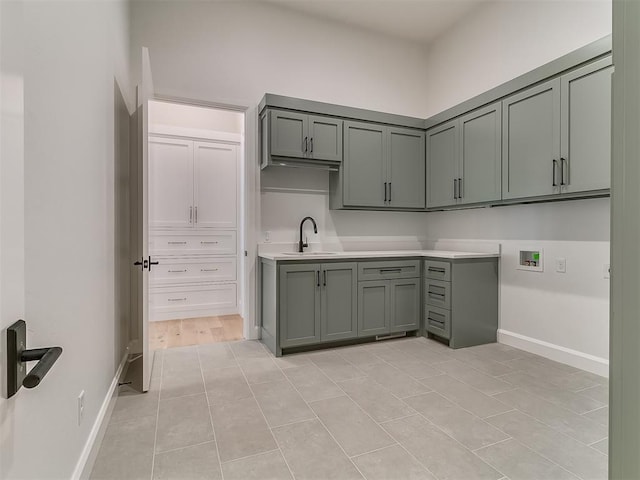 kitchen featuring light tile patterned floors and sink