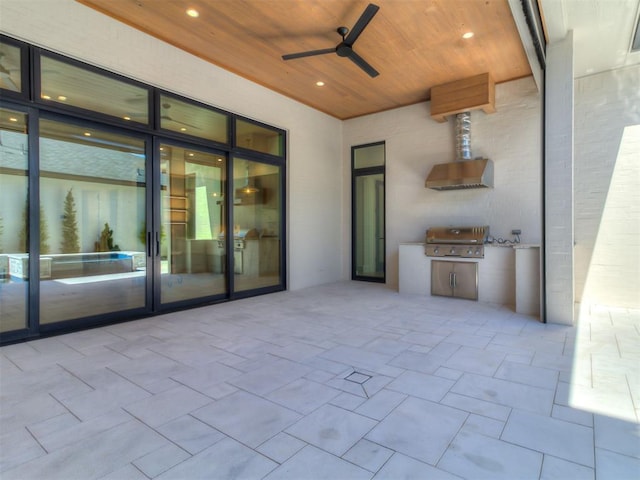 view of patio / terrace featuring ceiling fan, a grill, and exterior kitchen