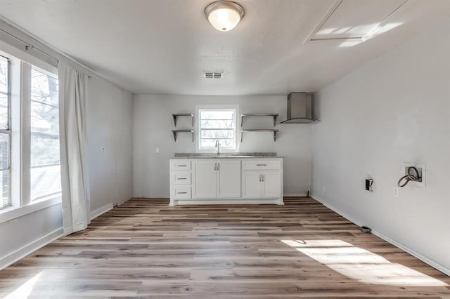 clothes washing area featuring sink and light wood-type flooring