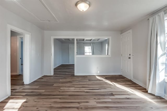 unfurnished room with hardwood / wood-style flooring