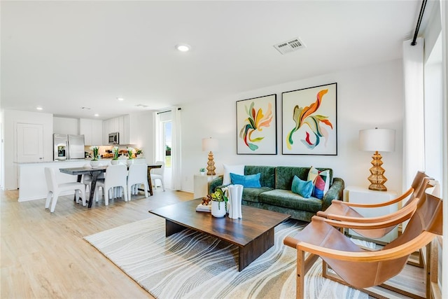 living room with light hardwood / wood-style flooring