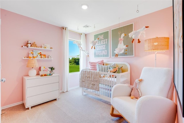 bedroom featuring light colored carpet and a crib