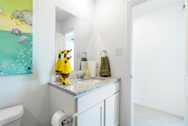 bathroom featuring vanity and toilet