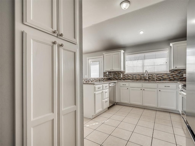 kitchen with dishwasher, white cabinetry, and light tile patterned floors