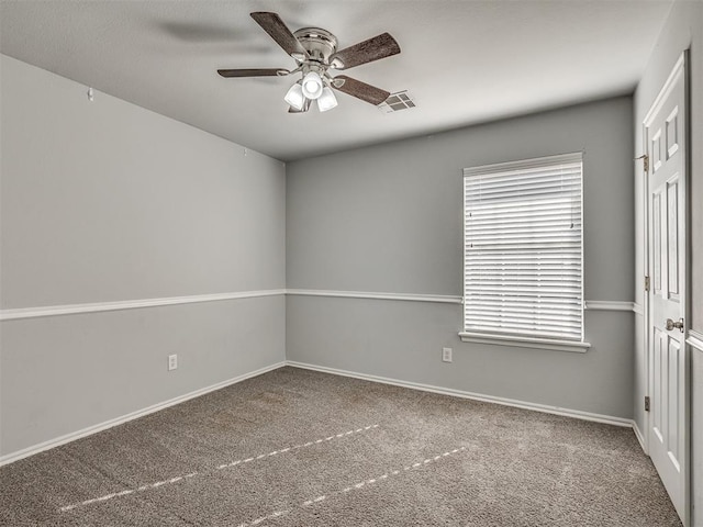 spare room featuring carpet flooring and ceiling fan