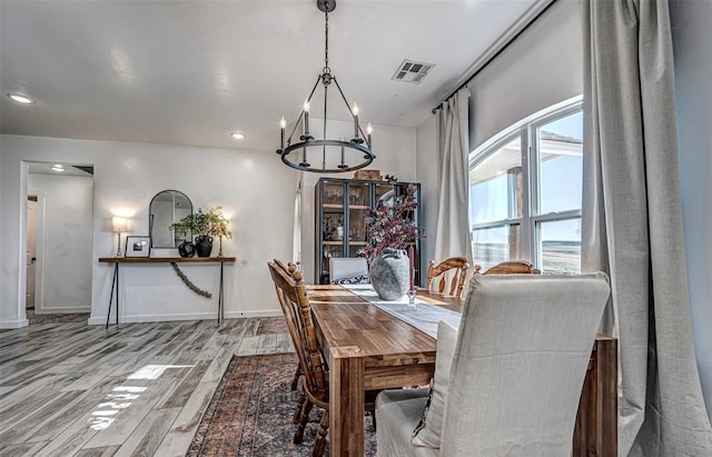 dining space with a wealth of natural light and an inviting chandelier