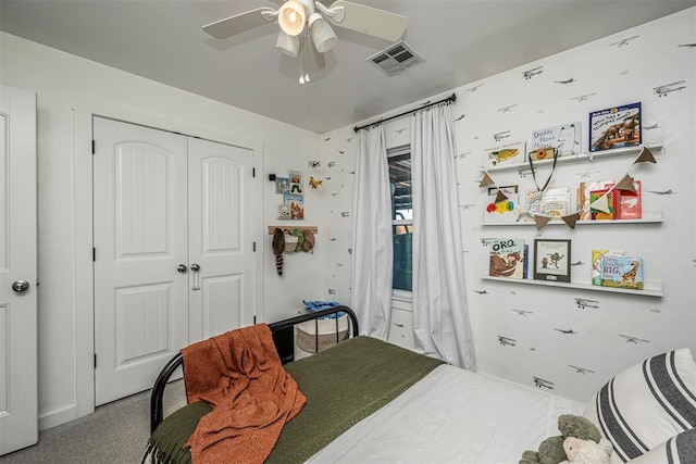 bedroom with ceiling fan, a closet, and carpet