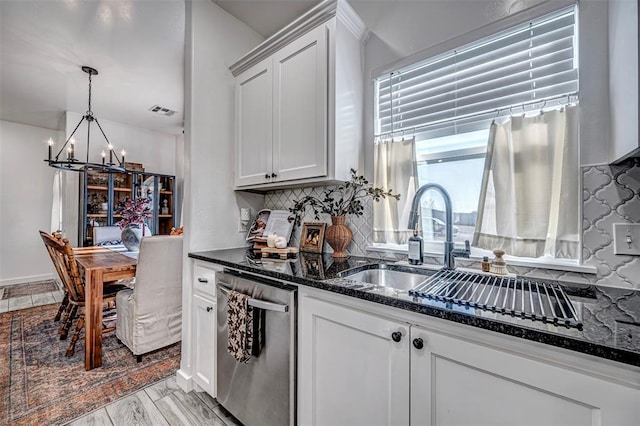 kitchen featuring dishwasher, decorative backsplash, and white cabinets