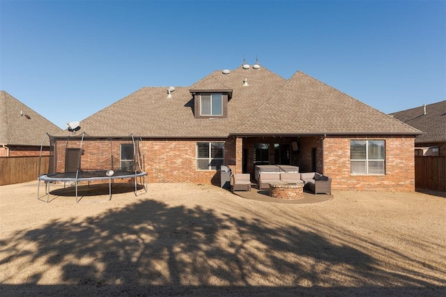 back of house with outdoor lounge area, a patio area, and a trampoline