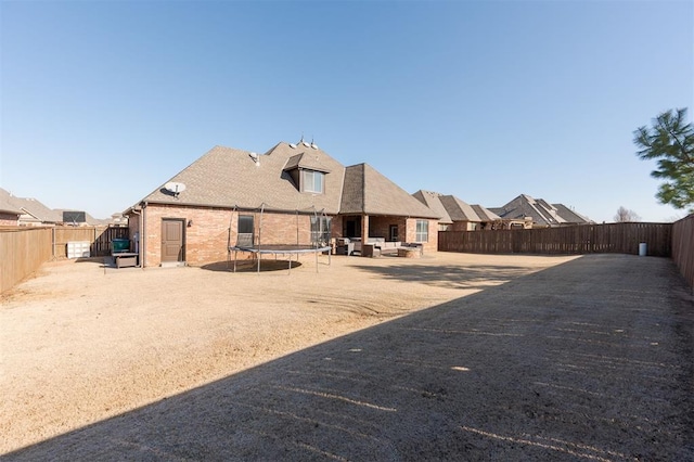 back of property with a trampoline