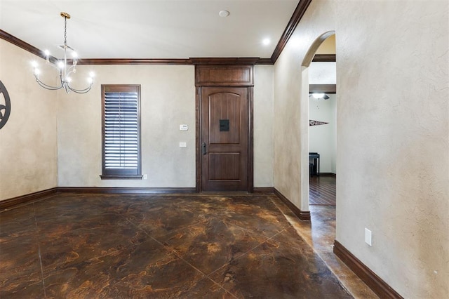 foyer entrance featuring ornamental molding and a notable chandelier