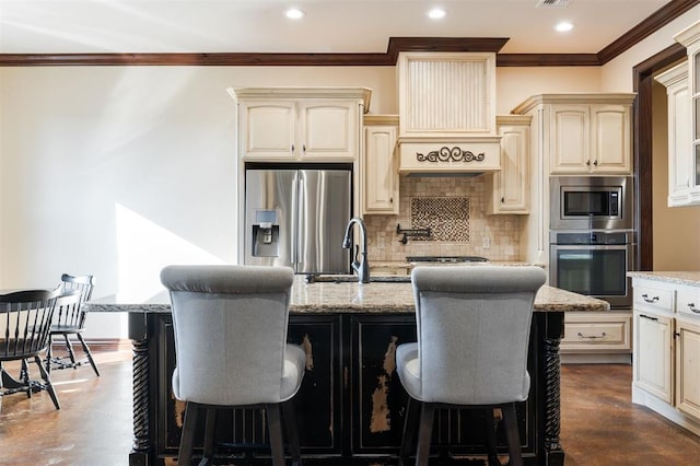 kitchen featuring tasteful backsplash, a kitchen island, stainless steel appliances, and cream cabinetry