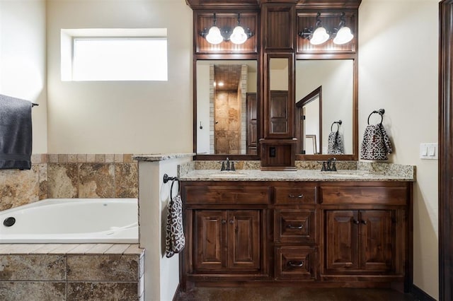 bathroom featuring vanity and a relaxing tiled tub