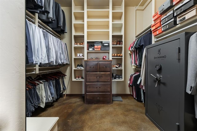 walk in closet featuring dark colored carpet