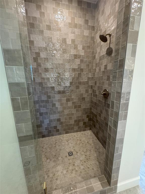 bathroom with a shower with door