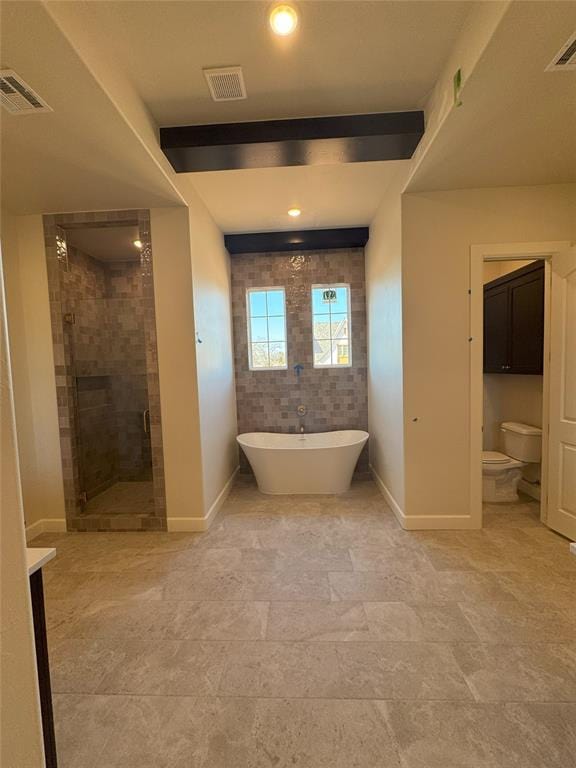 full bath featuring a freestanding tub, a shower stall, visible vents, and baseboards