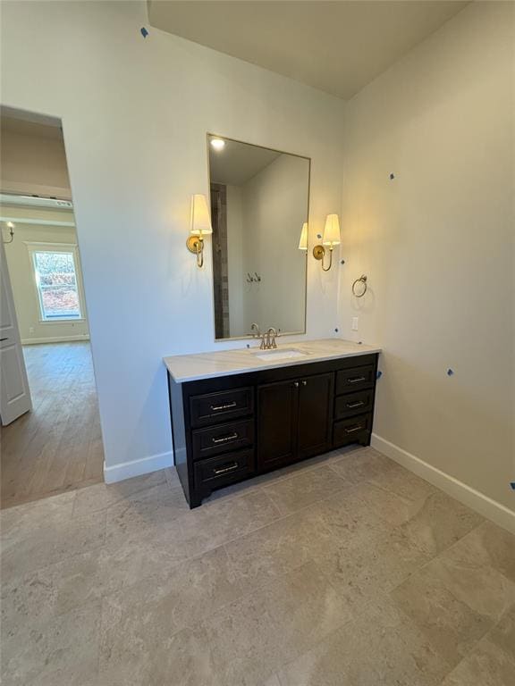 bathroom with vanity and baseboards