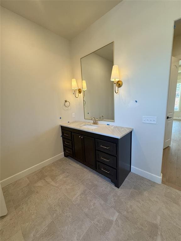 bathroom with baseboards and vanity